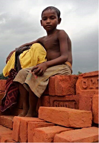 Boy sitting on bricks, supported by Elimination of Kala Azar – BTSP program - CARE India